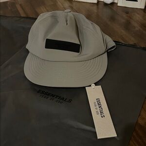 (2) Fear of God Essentials (1) Gray and (1) Black Cap